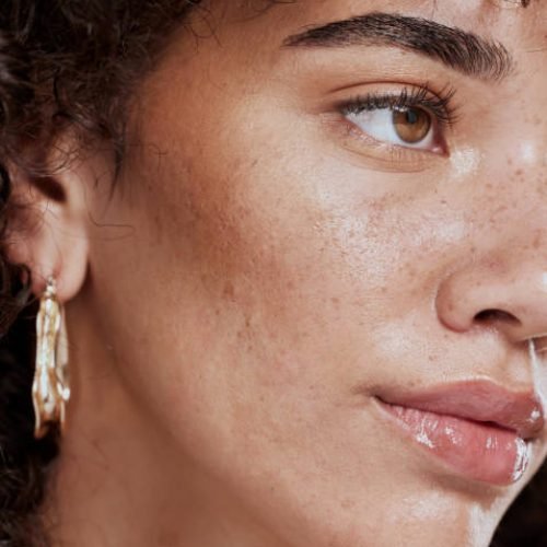 Closeup, woman and skincare for wellness, natural beauty and confident for makeup brand and fresh. Makeup, female or healthy girl happy, with freckles and smooth face for organic facial and cosmetics